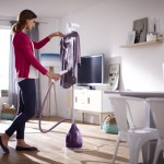 Woman-using-the-Philips-ClearTouch-Essence-Garment-Steamer